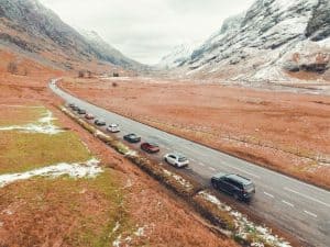 line of parked cars on a road in the Scottish Highlands on a Waynes World Of Wheels dramatic drive