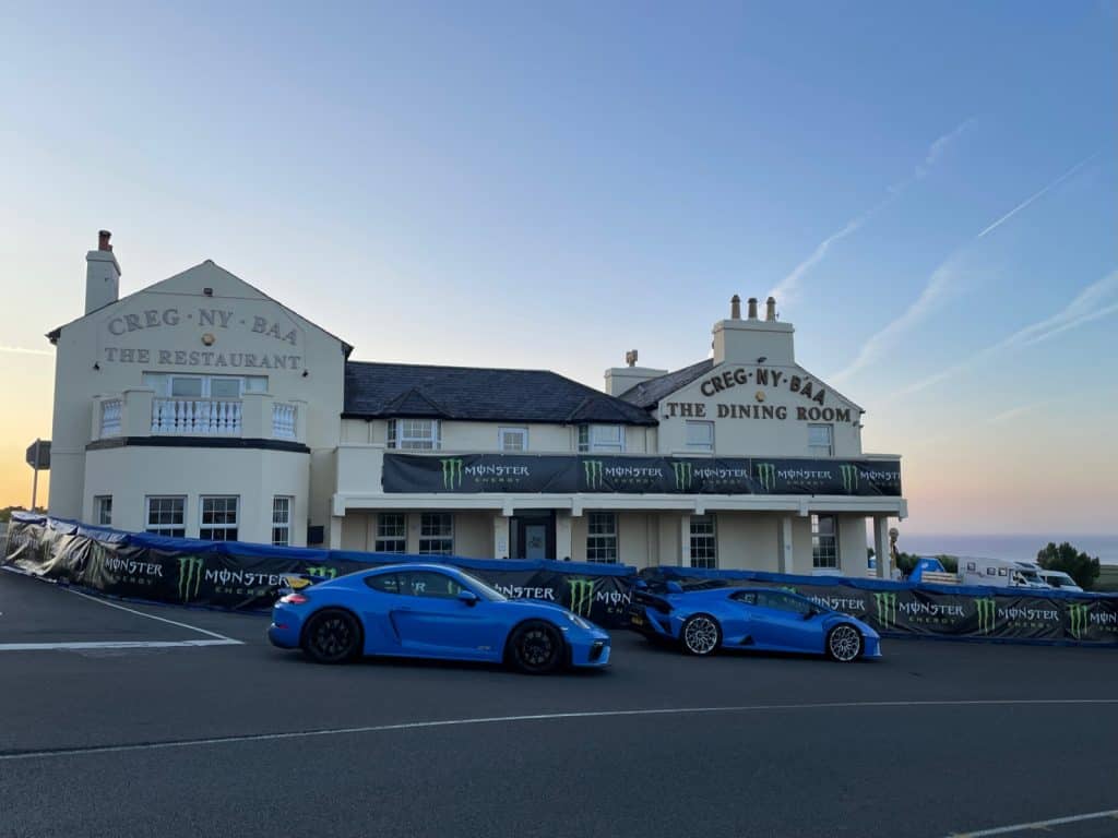 2 supercars parked in front of the Creg-Ny-Baa Pub in the Isle Of Man with Wayne's World Of Wheels