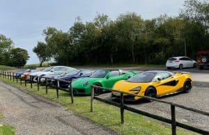 a number of supercars parked in a row in The Cotswolds while on a Waynes World Of Wheels Super car drive