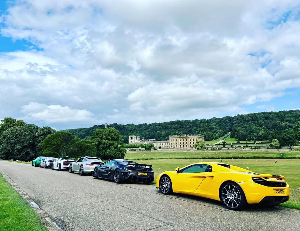 group of Supercars parked in the countryside in the grounds of Chatsworth House on the WWOW Derbyshire Donut day drive