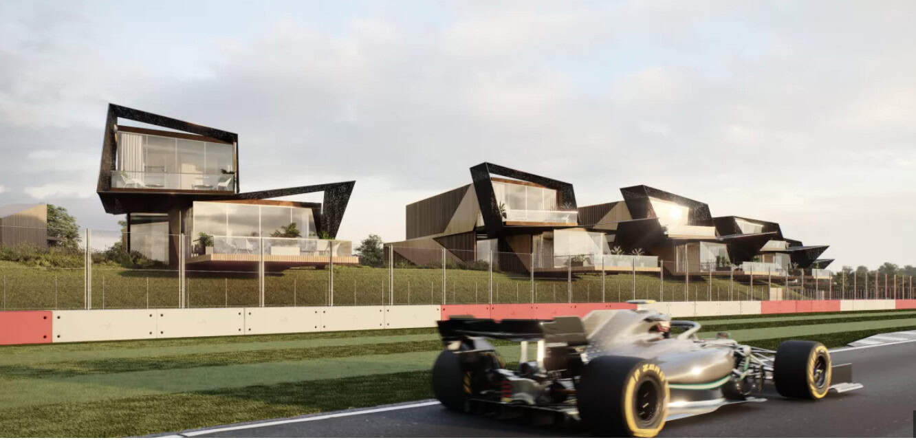Formula 1 racing car driving at speed past Escapade Hotel at Silverstone