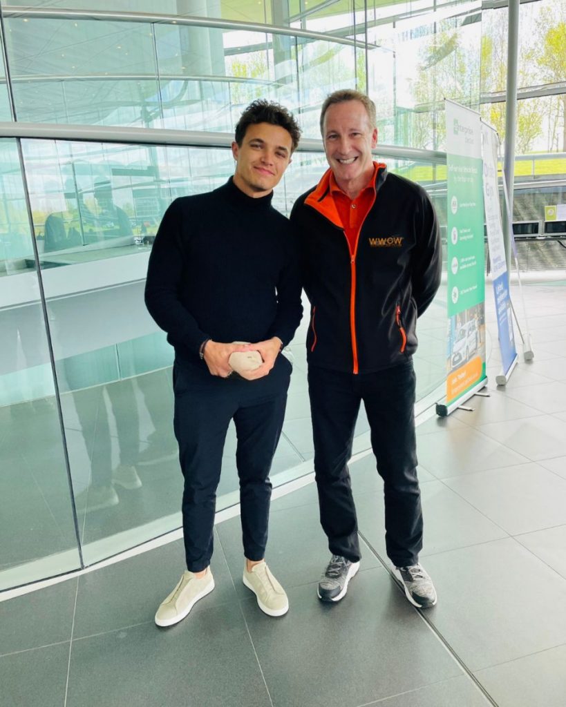 Wayne Lowery owner of Waynes World Of Wheels supercar club standing with Lando Norris inside the Mclaren Headquarters